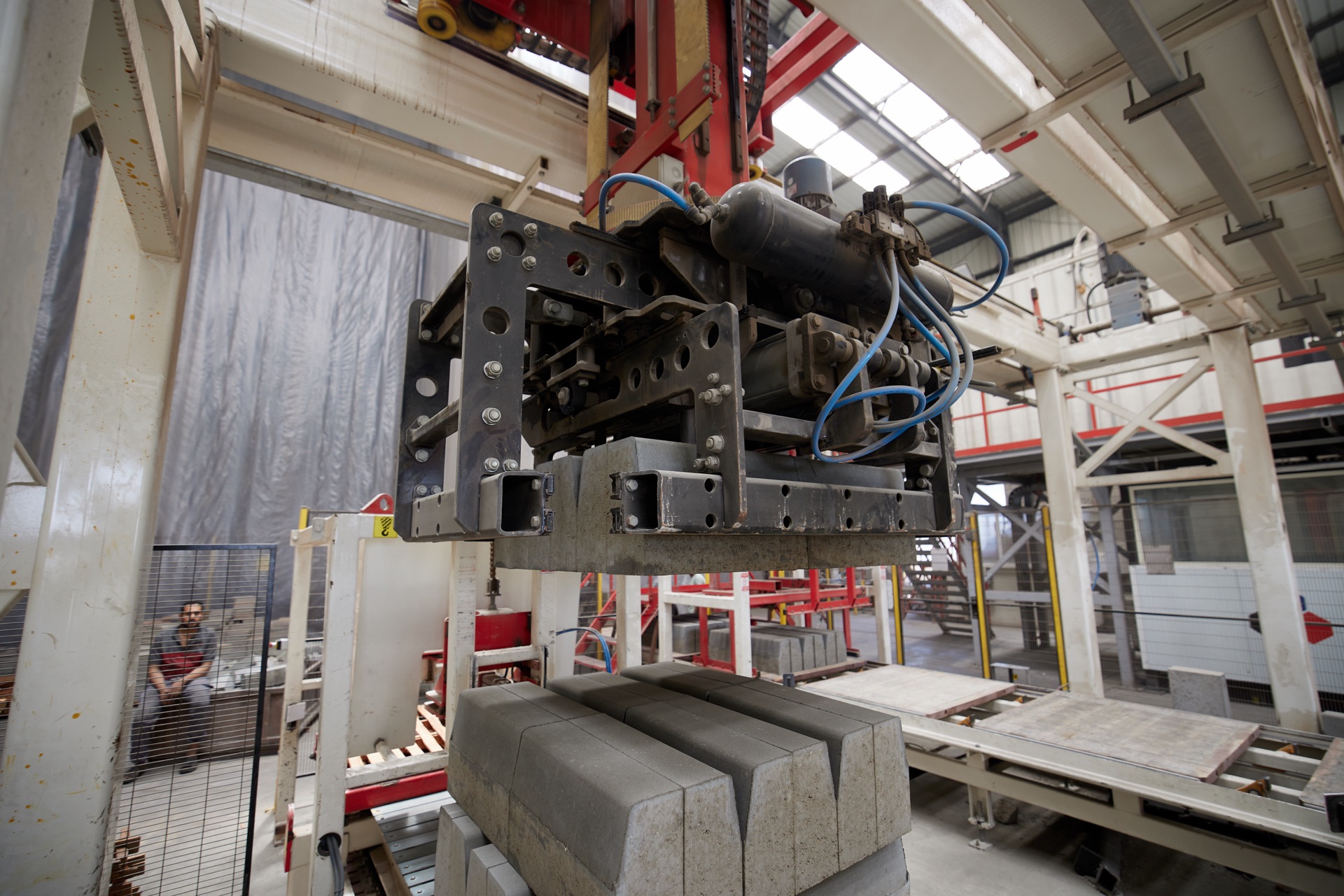 Hydraulic press placing precast concrete units on the Egycrete production line